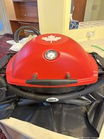 Top view showing red lid with maple leaf and built-in thermometer