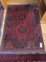 Full view of hand knotted wool rug showing design and condition