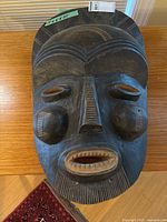 Full frontal view of carved wooden mask