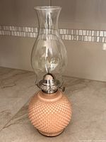 Full view of Kaadan pink hobnail oil lamp with chimney