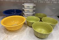 All items grouped: 2 Pyrex bowls, 4 CorningWare casseroles with lids, 4 green Rachael Ray bowls
