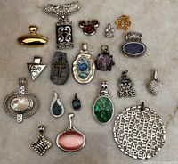 All nineteen costume pendants laid out for full view