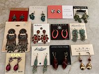 All 12 carded earring pairs displayed on surface