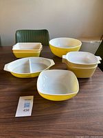 Group shot of all yellow Pyrex and Corning Ware pieces on table