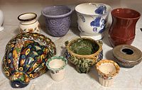 Full lot of nine ceramic pieces displayed together
