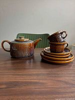 Complete set showing teapot, stacked plates, cups