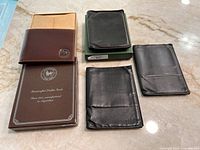Group shot of four wallets and box