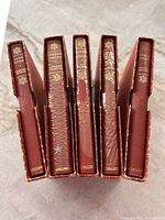 Top view of five red slipcased Collins Classics books