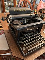 Three-quarter left front view showing overall condition, keys and ribbon spools