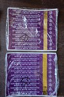 Two shrink-wrapped bundles of purple South Frontenac garbage tags