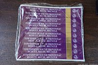 Stack of Township of South Frontenac garbage bag tags in plastic wrap