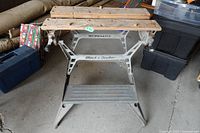 Front view of Black & Decker Workmate showing full frame, wooden top, step