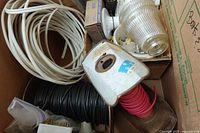 Overview showing white wire coil, black wire coil, pink wire spool, light fixtures boxes