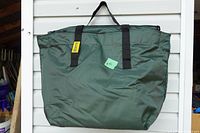 Front view of olive green Hunters Specialties bag showing handles, top zipper, brand tag, and overall condition