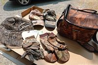 Group shot of all items laid out: two caps, head net, gloves, mittens, cooler