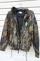 Front view of Coleman camouflage hooded jacket on hanger
