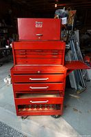 Overall view of both red tool chests stacked, drawers open