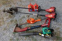 All tools laid out on gravel surface