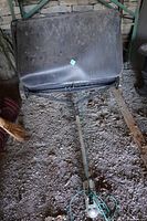 Full view of tow-behind lawn sweeper showing tow bar and hopper