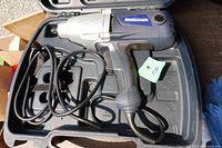 Impact wrench inside carry case with cord visible