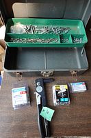 Rivet gun, metal case, loose and packaged rivets visible