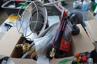 Box containing propane heater head, new packaged hose-regulator assemblies and coiled used hoses