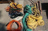 Overview of extension cords, power strip, ropes on ground
