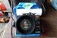 Front view of Vexilar FL-18 sonar on blue shuttle with foam float and wiring visible