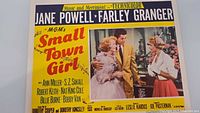 Front of lobby card showing full design, title, cast, scene image, and border graphics