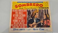Front of Sombrero lobby card showing artwork, title, actors, credits