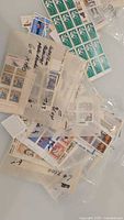 Multiple bags containing assorted mint Canadian stamp blocks and sheets