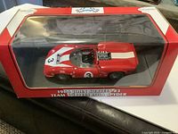 Boxed 1:18 scale Lola Spyder model showing front and side