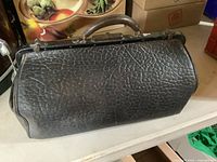 Full view of doctor’s bag showing textured black leather exterior and overall shape