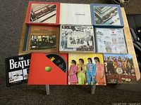 All seven CD albums laid out, some opened to show discs and booklets