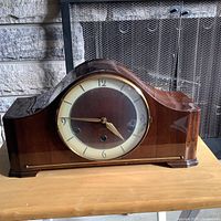 Front view of mantel clock showing case and dial