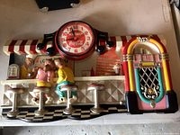 Front view showing complete soda fountain scene, clock dial and jukebox