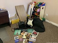 Overall lot with guitar on stand, amplifier, bag, books, accessories