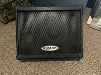 Front view of Kustom speaker showing grille and logo