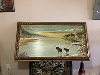 Full view of framed wilderness oil painting