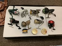 All eight reels and two tins laid out