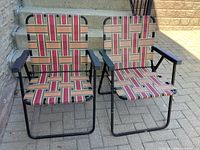 Front view of both matching metal folding lawn chairs