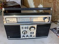 Front view showing tuner dial, controls, speakers, and 8-track slot