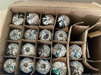 Open carton showing 18 foil sausage packs separated in cardboard dividers