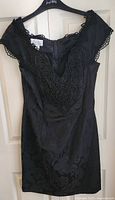 Front view of Scott McClintock black velvet dress showing bead-embroidered neckline
