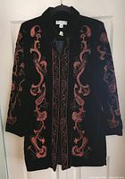 Front of black velvet jacket with copper paisley embroidery