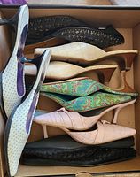 Box showing all six pairs of shoes stacked