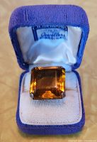 Ring in blue presentation box showing stone and setting