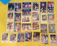Full layout of approximately 25 basketball cards on yellow surface