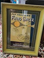 Front view of framed Disneyland Flying Saucer poster