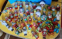 Full lot of robot, astronaut and space-themed ornaments spread on table